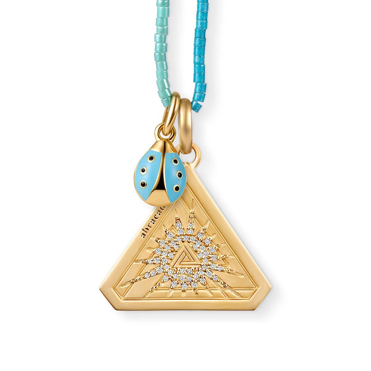 Small Silver Abracadabra Starburst Triangle Series 7 paired beautifully with Light Blue Ladybug and India Beaded Necklace.